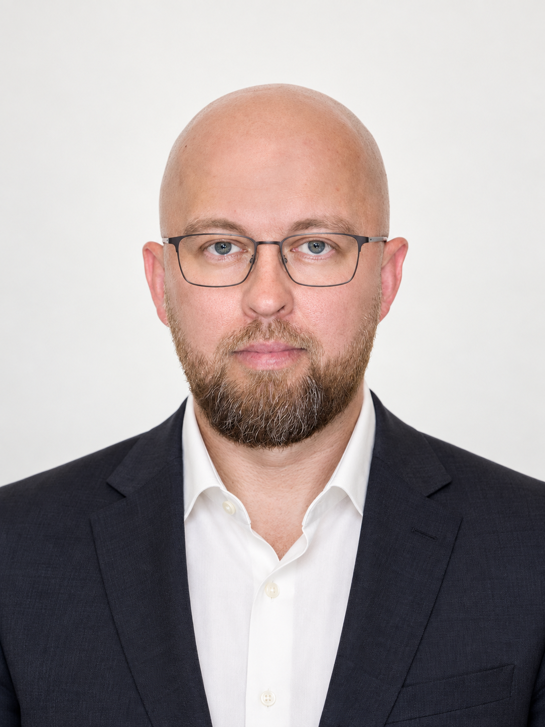 Vyacheslav Alekseev wearing a dark suit and glasses